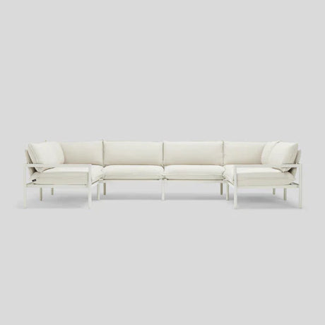 The Terra Sectional is a white, modern sofa with a metal frame and cushioned seats, organized in an L-shape on a light gray background.