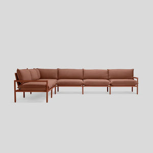 Introducing the Terra Sectional: a spacious, L-shaped brown sofa with a minimalist aesthetic set against a light gray background. It boasts elegant thin armrests and backrests, complemented by plush cushions that provide exceptional seating comfort and support.