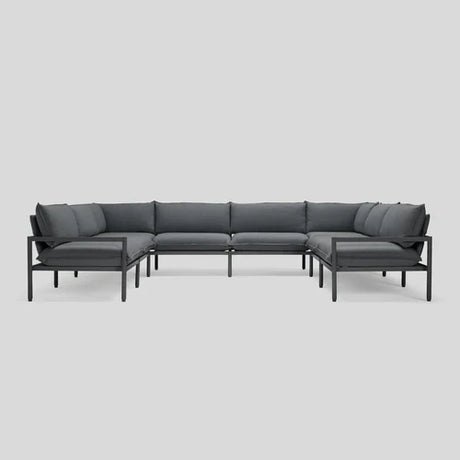 The Terra Sectional, featuring a modern L-shaped design with dark gray cushions and a sleek black metal frame, is showcased against a plain white background.