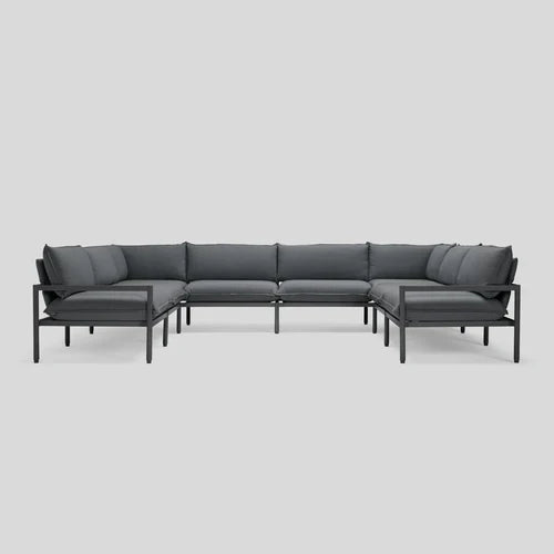 The Terra Sectional, featuring a modern L-shaped design with dark gray cushions and a sleek black metal frame, is showcased against a plain white background.
