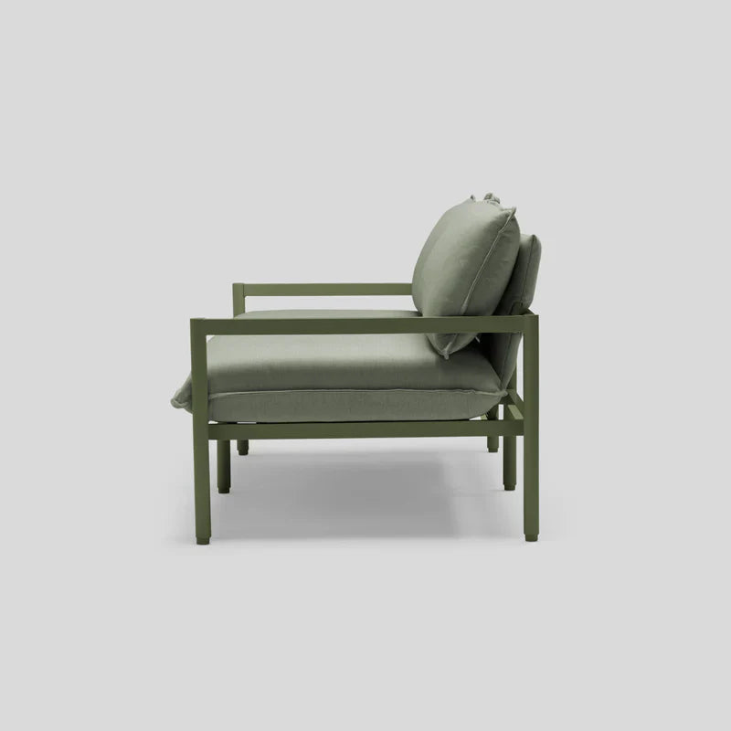 Terra Loveseat in modern green featuring a metal frame with cushioned seat and backrest, viewed from the side against a plain gray background.