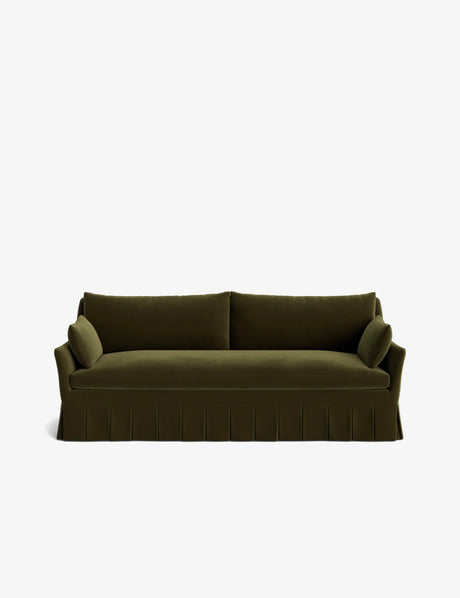 The Portola Pleated Sofa, with its dark green hue and two cushion arms, stands against a white background. It features a pleated skirt and boasts a clean, modern design characterized by straight lines and a plush appearance.