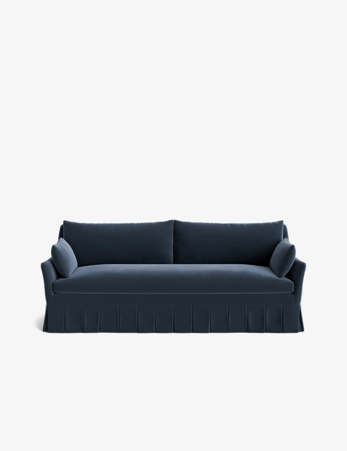 A Portola Pleated Sofa in dark blue upholstery featuring a tailored skirt and large cushions on the back and sides, showcased against a plain white background.