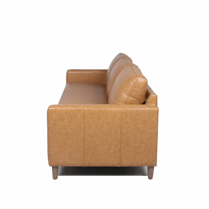 Side view of the Portland 80.5" Leather Sofa in tan leather, featuring wooden legs. The sofa showcases a contemporary design with cushioned seats and backrest, accentuated by its simple, clean lines.