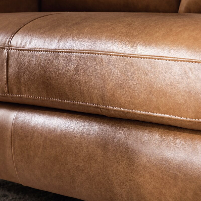 Close-up of the Portland 80.5" Leather Sofa in tan, showcasing visible stitching details. The leather features a smooth texture and subtle sheen, highlighting the quality of the upholstery.