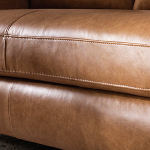 Close-up of the Portland 80.5" Leather Sofa in tan, showcasing visible stitching details. The leather features a smooth texture and subtle sheen, highlighting the quality of the upholstery.