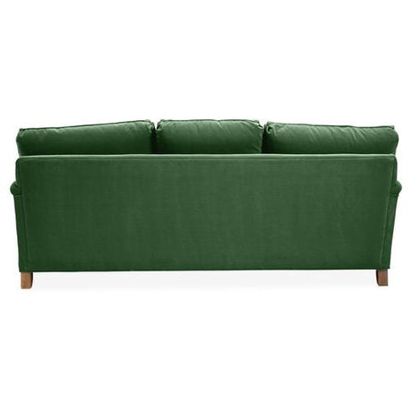 The Brooke 6-Seat Sofa, pictured from the rear, showcases a straightforward, modern design with three plush seat cushions and wooden legs in a green hue.