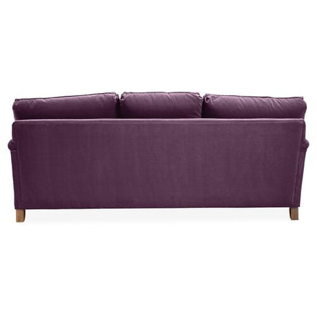 The Brooke 6-Seat Sofa, seen from the rear view, features a sleek, modern design with three cushion backs in a purple hue and wooden legs.
