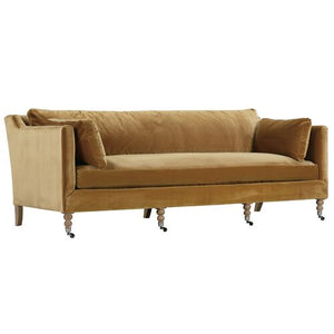 Introducing the Margot Velvet Sofa, a sleek, modern piece in a vibrant mustard-yellow hue. This sofa boasts a straight back and cushioned armrests for ultimate comfort and is elegantly supported by wooden legs with caster wheels. Completing the look are two matching throw pillows included with your purchase.