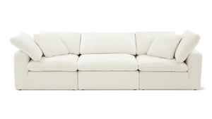 The Movie Night 3-Piece Modular Sofa is a plush, white sectional with three seats, adorned with five matching cushions. It showcases clean lines and a minimalist design, all set against a plain white background.