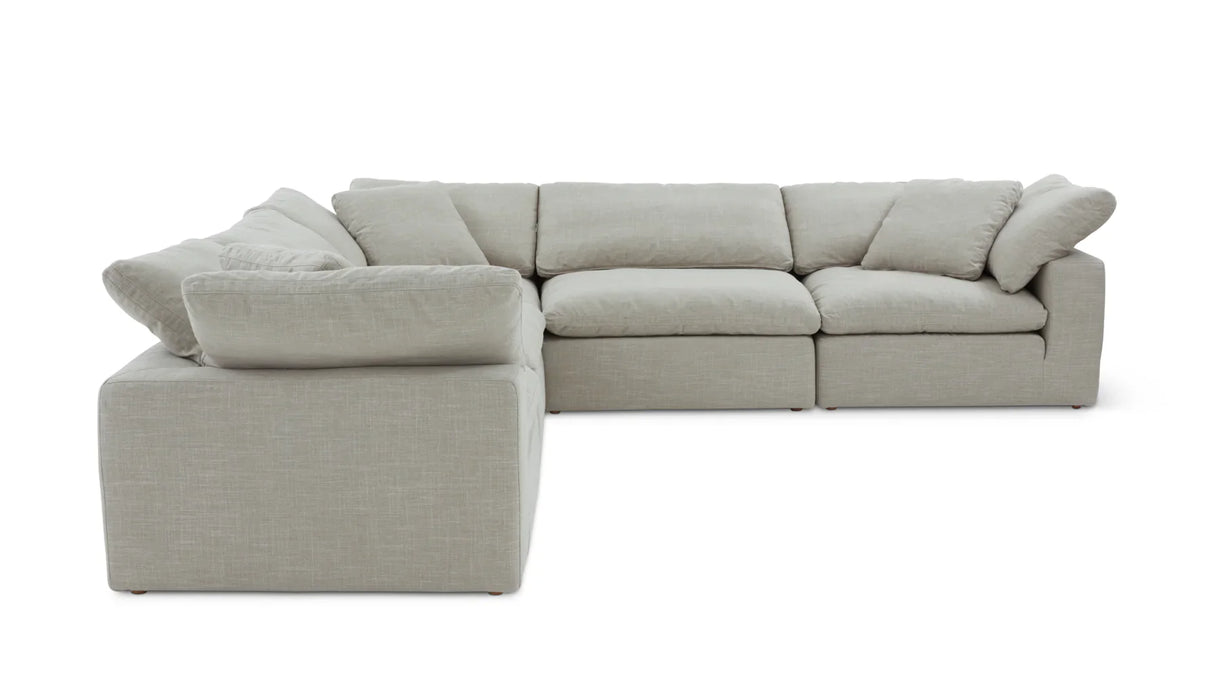 Introducing the Movie Night 3-Piece Modular Sofa, a light gray sectional that boasts an L-shaped design with thick cushions. This sofa exudes modern minimalism, featuring fabric upholstery and plush back and seat cushions that offer an invitingly cozy seating experience.