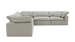Introducing the Movie Night 3-Piece Modular Sofa, a light gray sectional that boasts an L-shaped design with thick cushions. This sofa exudes modern minimalism, featuring fabric upholstery and plush back and seat cushions that offer an invitingly cozy seating experience.