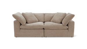 A beige, plush three-piece modular sofa with detachable cushions on both the seat and backrest, set against a plain white background.