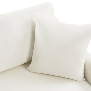 A Torsten Modern Comfortable Sofa with a matching white cushion placed on it. The fabric looks soft and smooth, seamlessly blending with the sofa's upholstered surface. Bright lighting highlights the texture of the textiles.