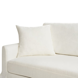 A white Torsten Modern Comfortable Sofa featuring a minimalist design, complete with a matching square pillow on the left side. The fabric looks soft and pristine, contributing to a simple, elegant appearance. The image highlights the left armrest and part of the seat cushion.