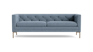 The Sit Tight 90" Sofa features a contemporary gray design with a tufted backrest and slim metal legs, set against a black background. It includes two large seat cushions and boasts a sleek, minimalist style.