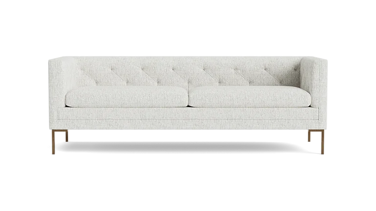 The Sit Tight 90" Sofa, featuring a white tufted design with two seat cushions and wooden legs, is displayed against a plain black background.