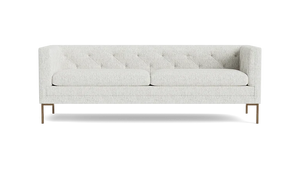 The Sit Tight 90" Sofa, featuring a white tufted design with two seat cushions and wooden legs, is displayed against a plain black background.