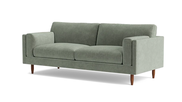 Introducing the Skinny Fat 85" Sofa Standard Depth—a sleek and contemporary sofa in a modern light green hue. This stylish piece includes two seat cushions and two back cushions, complemented by straight armrests and supported by four wooden legs.