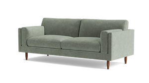 Introducing the Skinny Fat 85" Sofa Standard Depth—a sleek and contemporary sofa in a modern light green hue. This stylish piece includes two seat cushions and two back cushions, complemented by straight armrests and supported by four wooden legs.