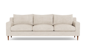 The Sloan Custom 3-Seat 95" Sofa features a beige finish, plush cushions, and wooden legs on a black background. It boasts a modern, minimalist design with clean lines.