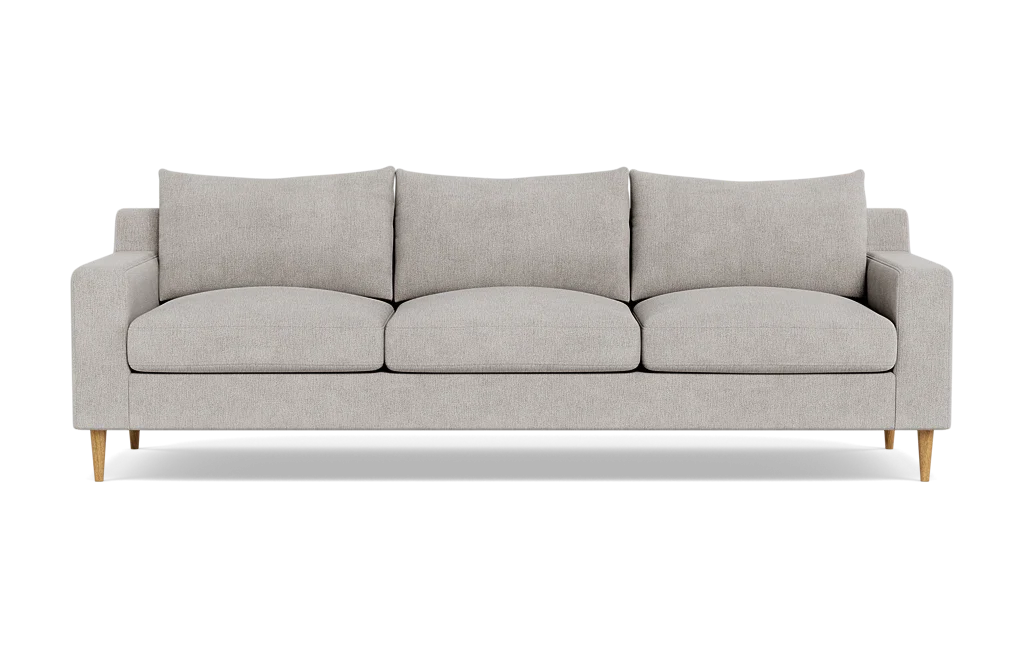 Introducing the Sloan Custom 3-Seat 95" Sofa, featuring a modern and minimalistic design with light gray upholstery. This three-seater has clean lines, cushioned backrests, and elegant wooden legs, all beautifully showcased against a plain black background.