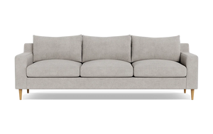 Introducing the Sloan Custom 3-Seat 95" Sofa, featuring a modern and minimalistic design with light gray upholstery. This three-seater has clean lines, cushioned backrests, and elegant wooden legs, all beautifully showcased against a plain black background.