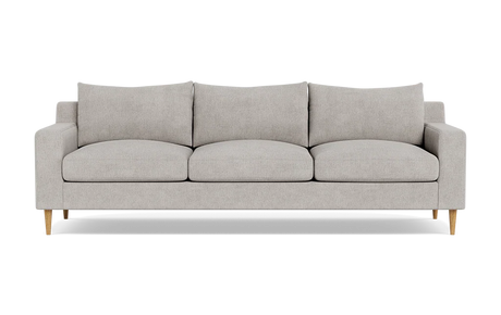 Introducing the Sloan Custom 3-Seat 95" Sofa, featuring a modern and minimalistic design with light gray upholstery. This three-seater has clean lines, cushioned backrests, and elegant wooden legs, all beautifully showcased against a plain black background.
