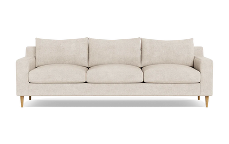 The Sloan Custom 3-Seat 95" Sofa features a beige color with a minimalist design, characterized by its clean lines, three cushions, and wooden legs, photographed against a plain black background.