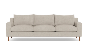 The Sloan Custom 3-Seat 95" Sofa is a modern beige sofa featuring streamlined, rectangular cushions and slim wooden legs, positioned against a plain black background.