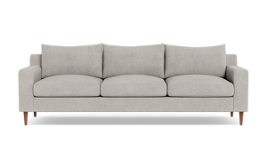 The Sloan Custom 3-Seat 95" Sofa features a modern design with a light gray finish, encompassing three seat cushions and three back cushions. Its clean, simple lines and wooden legs contribute to its minimalist and stylish look. The sofa is presented against a plain black background.