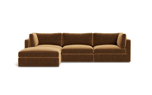 The Tatum Modular 3 Seat Chaise Sectional is a brown sofa with three seat cushions and an extended chaise lounge on the left. It showcases plush back cushions and a modern design, set against a plain black background.