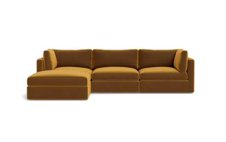 A Tatum Modular 3 Seat Chaise Sectional in mustard yellow, showcasing clean lines and plush cushions against a plain black background, features a left-side chaise for a sleek and modern design.