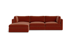 Introducing the Tatum Modular 3 Seat Chaise Sectional, a contemporary red-brown sofa with clean lines and a minimalist design, set against a solid black background. This sectional features a left-side chaise for an extended seating area.
