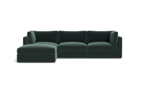 The Tatum Modular 3 Seat Chaise Sectional, featuring sleek cushions and a left-sided chaise in dark green, is set against a plain black background.