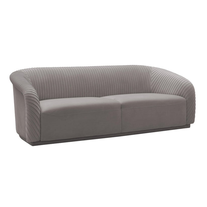 The Yara Pleated Velvet Sofa by Inspire Me! Home Decor is a contemporary piece featuring a rounded backrest and armrests. It is upholstered in modern gray velvet with a vertically stitched pattern, making it a sleek addition that complements various interior styles.