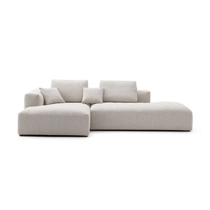 The 5th Open 116" Left Facing Sectional is a modern, minimalist beige sectional sofa featuring clean lines and plush cushions. It includes a chaise lounge on one side, perfect for a contemporary living room setting, and is showcased against a white background.