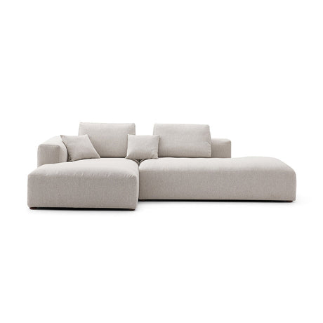 The 5th Open 116" Left Facing Sectional is a modern, minimalist beige sectional sofa featuring clean lines and plush cushions. It includes a chaise lounge on one side, perfect for a contemporary living room setting, and is showcased against a white background.