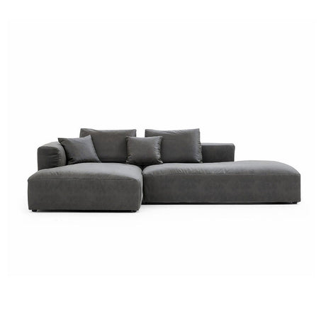 Introducing The 5th Open 116" Left Facing Sectional, a sleek dark gray sofa embodying modern minimalism. Its design includes two spacious central cushions complemented by smaller end cushions, offering a cozy and welcoming seating experience.