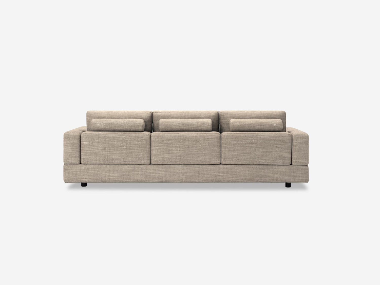 A beige Stage Track Sofa with a minimalist design, featuring three seat cushions and three back cushions, set against a plain white background. Its low profile is complemented by simple, block-like armrests.