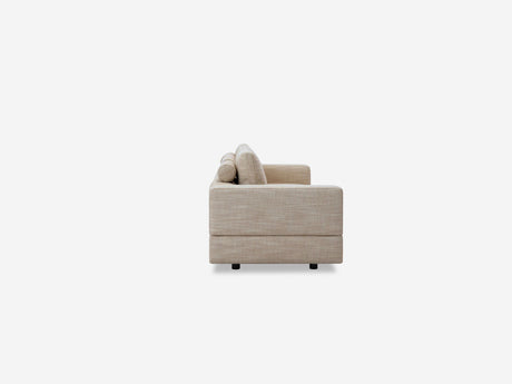 Side view of the Stage Track Sofa, featuring beige upholstery and cushions, set against a plain white background. The sofa showcases a modern, minimalist design.
