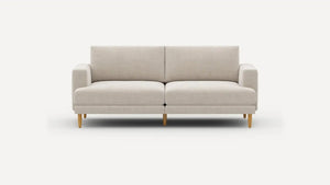 The Ember Mid-Century Modern 75" Sofa, featuring a sleek beige design and wooden legs, is showcased against a plain white background. It boasts a minimalist style with cushioned seats and armrests.