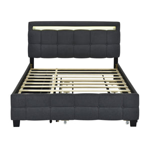 The Upholstered Platform Bed with LED Frame, featuring a modern black design and a tall tufted headboard with built-in lighting, showcases wooden slats and exudes a sleek, contemporary style. It includes a trundle and two drawers for added functionality.