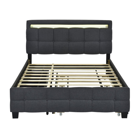 The Upholstered Platform Bed with LED Frame, featuring a modern black design and a tall tufted headboard with built-in lighting, showcases wooden slats and exudes a sleek, contemporary style. It includes a trundle and two drawers for added functionality.