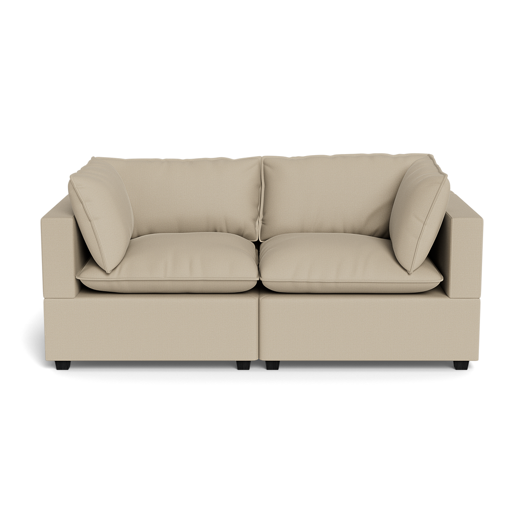 The Kova Pillow Cushion Sofa 86" is a beige, modern two-seater with square arms, plush seat and back cushions, plus two matching side pillows, displayed against a plain black background.
