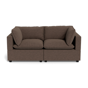 The Kova Pillow Cushion Sofa 86" is a modern brown two-seater with square arms and plush seat and back cushions, shown against a plain black background.