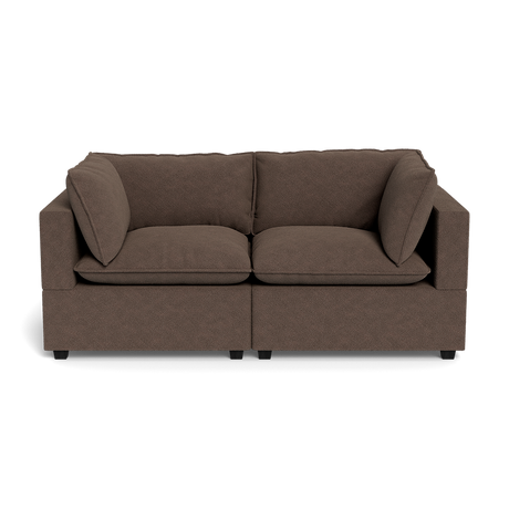The Kova Pillow Cushion Sofa 86" is a modern brown two-seater with square arms and plush seat and back cushions, shown against a plain black background.