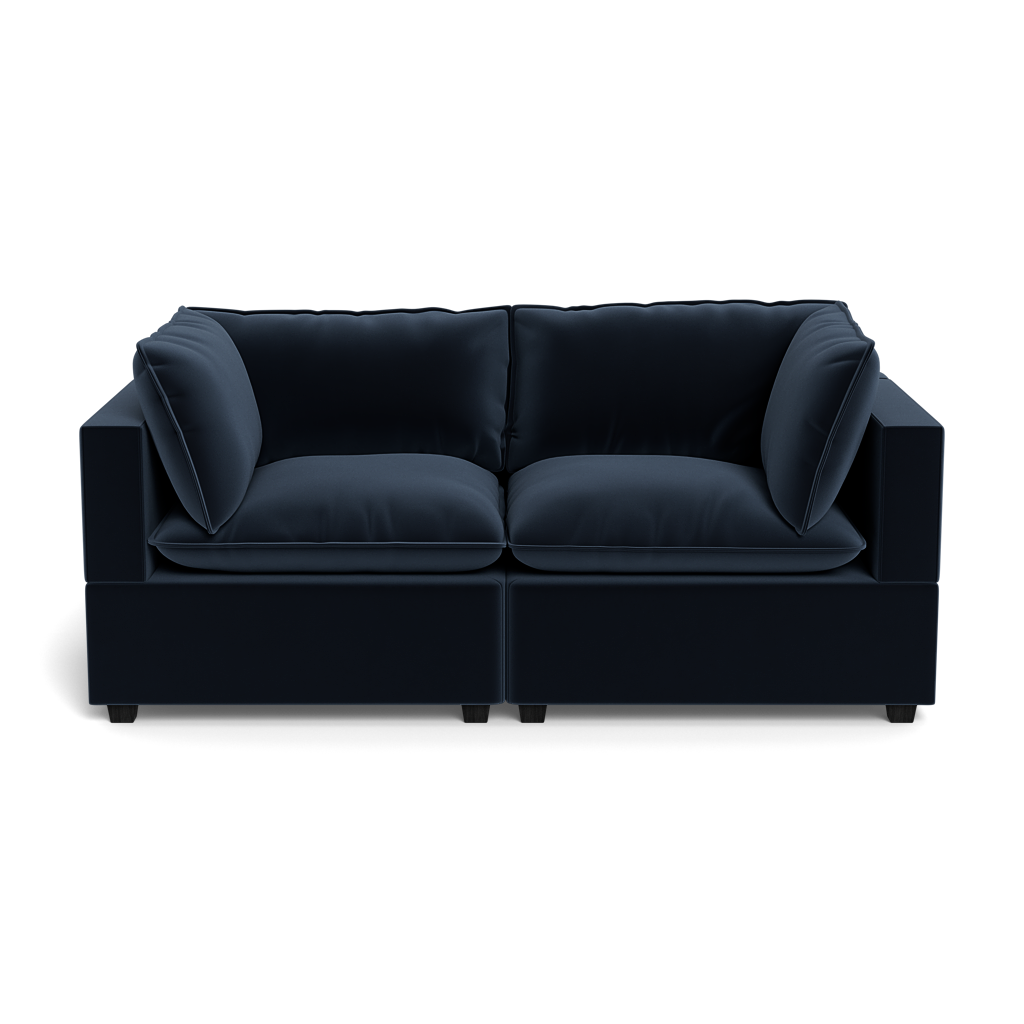 The Kova Pillow Cushion Sofa 86" is a modern dark blue velvet sofa with thick cushions and square armrests, shown from the front against a plain black background.