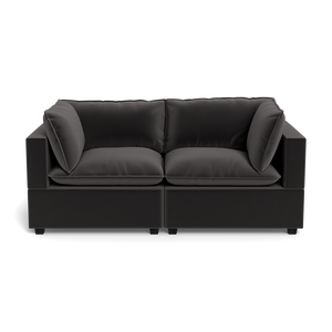 The Kova Pillow Cushion Sofa 86" is a modern black two-seater with thick cushions and large square armrests, shown from the front against a plain black background.