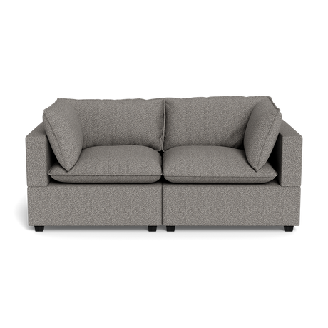 The Kova Pillow Cushion Sofa 86" is a modern gray upholstered sofa featuring two seat cushions and two large matching backrest pillows, displayed against a black background.